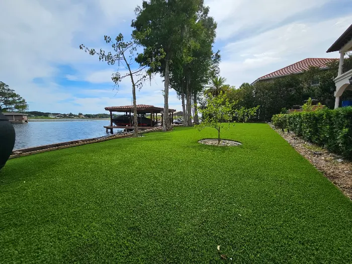 Stunning artificial grass lawn in front of lake