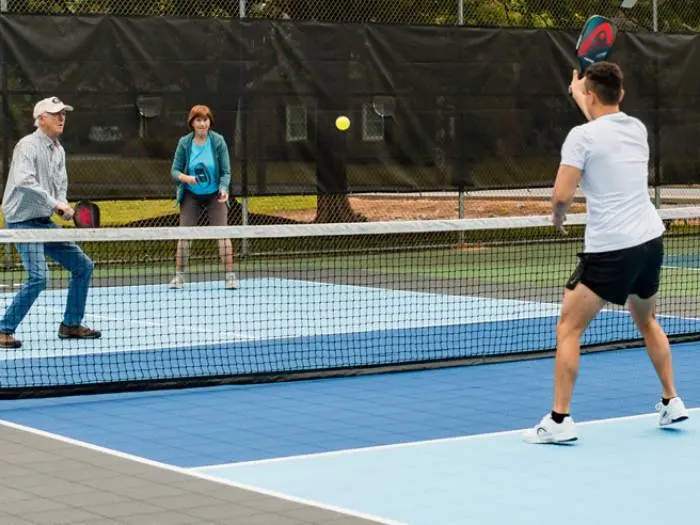 People playing pickleball in court